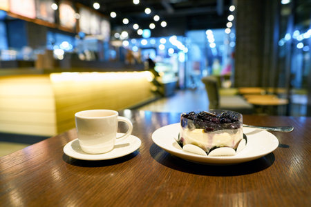 SEOUL, SOUTH KOREA - CIRCA MAY, 2017: a cup of coffee and blueberry cheese cake on a table in Starbucks. Starbucks Corporation is an American coffee company and coffeehouse chain.のeditorial素材