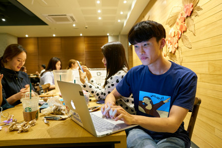SEOUL, SOUTH KOREA - CIRCA MAY, 2017: people at Starbucks in Seoul. Starbucks Corporation is an American coffee company and coffeehouse chain.のeditorial素材