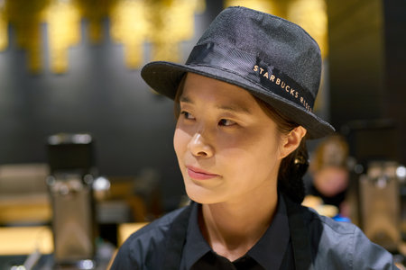 SEOUL, SOUTH KOREA - CIRCA MAY, 2017: indoor portrait of a worker at Starbucks Reserve. Starbucks Corporation is an American coffee company and coffeehouse chain.のeditorial素材