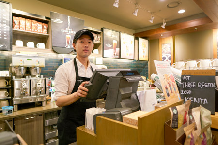 SEOUL, SOUTH KOREA - CIRCA MAY, 2017: worker at Starbucks. Starbucks Corporation is an American coffee company and coffeehouse chain.のeditorial素材