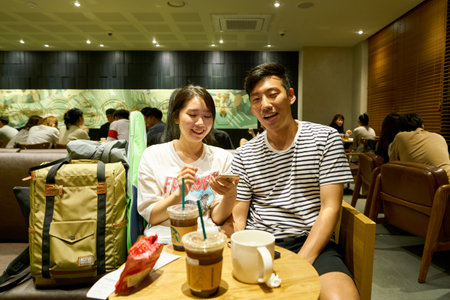 SEOUL, SOUTH KOREA - CIRCA MAY, 2017: people at Starbucks in Seoul. Starbucks Corporation is an American coffee company and coffeehouse chain.のeditorial素材