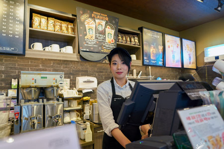 SEOUL, SOUTH KOREA - CIRCA MAY, 2017: indoor portrait of a worker at Starbucks. Starbucks Corporation is an American coffee company and coffeehouse chain.のeditorial素材
