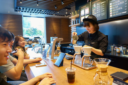 SEOUL, SOUTH KOREA - CIRCA MAY, 2017: worker at Starbucks Reserve. Starbucks Corporation is an American coffee company and coffeehouse chain.のeditorial素材