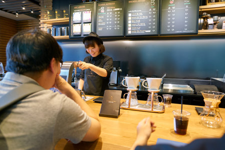 SEOUL, SOUTH KOREA - CIRCA MAY, 2017: worker at Starbucks Reserve. Starbucks Corporation is an American coffee company and coffeehouse chain.のeditorial素材