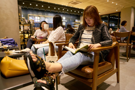 SEOUL, SOUTH KOREA - CIRCA MAY, 2017: people at Starbucks in Seoul. Starbucks Corporation is an American coffee company and coffeehouse chain.のeditorial素材