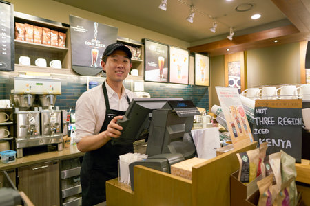 SEOUL, SOUTH KOREA - CIRCA MAY, 2017: worker at Starbucks. Starbucks Corporation is an American coffee company and coffeehouse chain.のeditorial素材