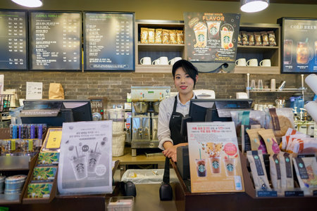 SEOUL, SOUTH KOREA - CIRCA MAY, 2017: indoor portrait of a worker at Starbucks. Starbucks...