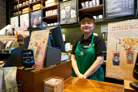 SEOUL, SOUTH KOREA - CIRCA MAY, 2017: worker at Starbucks. Starbucks Corporation is an American coffee company and coffeehouse chain.のeditorial素材