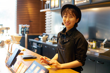 SEOUL, SOUTH KOREA - CIRCA MAY, 2017: indoor portrait of a worker at Starbucks Reserve. Starbucks Corporation is an American coffee company and coffeehouse chain.のeditorial素材