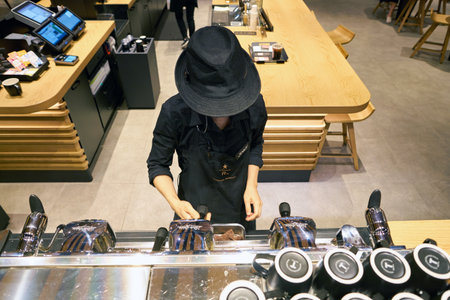 SEOUL, SOUTH KOREA - CIRCA MAY, 2017: worker at Starbucks Reserve. Starbucks Corporation is an American coffee company and coffeehouse chain.のeditorial素材