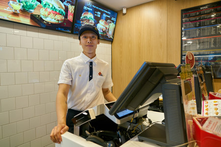 SEOUL, SOUTH KOREA - CIRCA MAY, 2017: indoor portrait of worker at McDonald's restaurant. McDonald's is an American hamburger and fast food restaurant chain.のeditorial素材