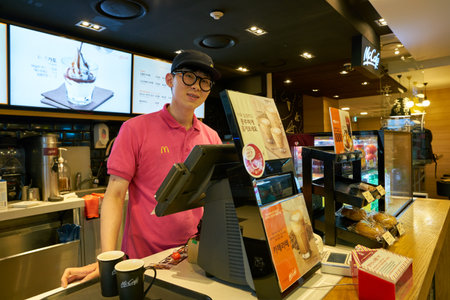 SEOUL, SOUTH KOREA - CIRCA MAY, 2017: worker at McCafe. McCafe is a coffee-house-style food and...
