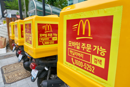 SEOUL, SOUTH KOREA - CIRCA MAY, 2017: McDonald's delivery motorbikes in Seoul. McDonald's is an American hamburger and fast food restaurant chain.のeditorial素材