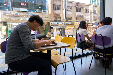 SEOUL, SOUTH KOREA - CIRCA MAY, 2017: people eat at McDonald's restaurant. McDonald's is an American hamburger and fast food restaurant chain.のeditorial素材