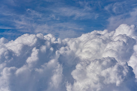 Aerial view of blue sky with clouds from jet flight