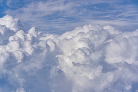 Aerial view of blue sky with clouds from jet flight