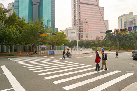 SHENZHEN, CHINA - DECEMBER 12, 2014: people crossing a road in ShenZhen. ShenZhen is regarded as one...
