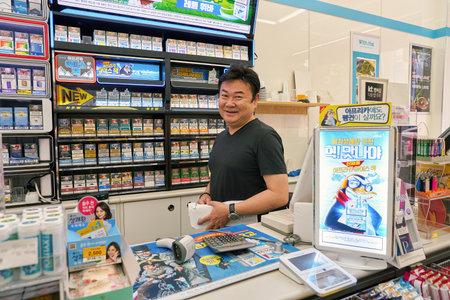 SEOUL, SOUTH KOREA - CIRCA MAY, 2017: indoor portrait of a worker at a convenience store in Seoul.のeditorial素材