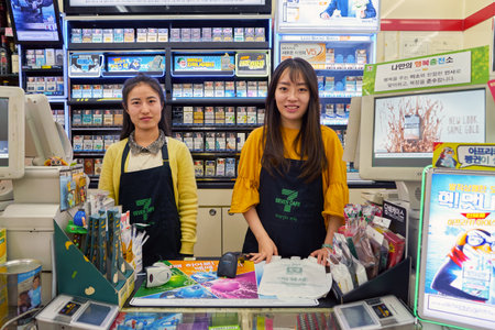 SEOUL, SOUTH KOREA - CIRCA MAY, 2017: indoor portrait of two women at at 7-Eleven convenience store. 7-Eleven is an international chain of convenience stores.のeditorial素材