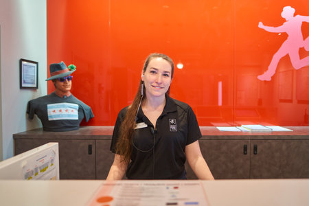 CHICAGO, IL, - CIRCA MARCH, 2016: friendly receptionist at Chicago Getaway Hostel front desk. Hostels provide budget-oriented, sociable accommodation where guests can rent a bed, usually a bunk bed, in a dormitory.のeditorial素材
