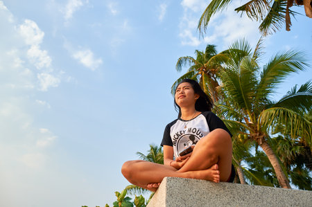 PATTAYA, THAILAND - CIRCA FEBRUARY, 2016: woman sitting alone and looking to sea in Pattaya. Pattaya is a resort city in Thailand. It is on the east coast of the Gulf of Thailandのeditorial素材