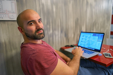 CHICAGO, IL, - CIRCA APRIL, 2016: man use notebook at Chicago Getaway Hostel. Hostels provide budget-oriented, sociable accommodation where guests can rent a bed, usually a bunk bed, in a dormitory.のeditorial素材