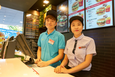 BUSAN, SOUTH KOREA - CIRCA MAY, 2017: indoor portrait of workers at McDonald's. McDonald's is an American hamburger and fast food restaurant chain.のeditorial素材