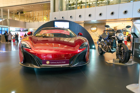 DOHA, QATAR - CIRCA MAY, 2017: red car on display at Hamad International Airport of Doha, the capital city of Qatar.のeditorial素材