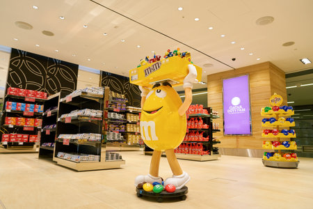 DOHA, QATAR - CIRCA MAY, 2017: M&M candy yellow character on display at Hamad International Airport of Doha, the capital city of Qatar.のeditorial素材