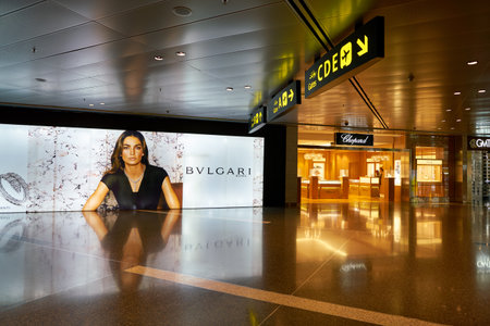 DOHA, QATAR - CIRCA MAY, 2017: Bvlgari advertisement and Chopard store at Hamad International Airport of Doha, the capital city of Qatar.のeditorial素材