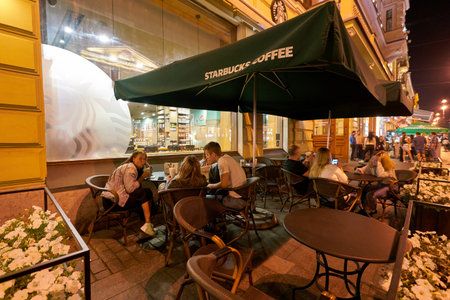 SAINT PETERSBURG, RUSSIA - CIRCA AUGUST, 2017: people at Starbucks coffee shop in Saint Petersburg. Starbucks Corporation is an American coffee company and coffeehouse chain.のeditorial素材