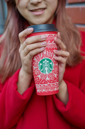 KALININGRAD, RUSSIA - CIRCA SEPTEMBER, 2017: woman hold Starbucks disposable paper coffee cup.のeditorial素材