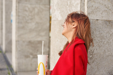 KALININGRAD, RUSSIA - CIRCA SEPTEMBER, 2017: outdoor portrait of pretty woman with McDonald's disposable paper cup.のeditorial素材
