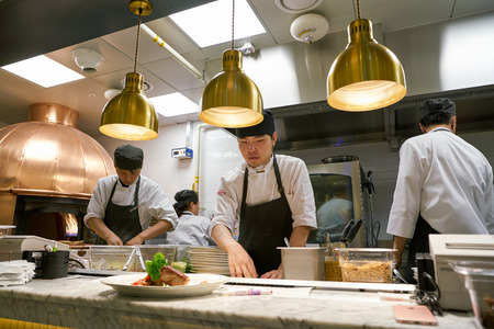 BUSAN, SOUTH KOREA - MAY 28, 2017: staff in modern open kitchen of The Place Italian bistro at Lotte Department Storeのeditorial素材