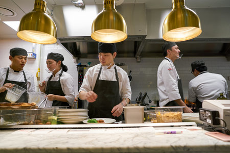 BUSAN, SOUTH KOREA - MAY 28, 2017: staff in modern open kitchen of The Place Italian bistro at Lotte Department Storeのeditorial素材