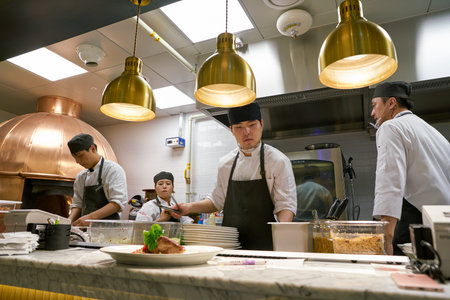 BUSAN, SOUTH KOREA - MAY 28, 2017: staff in modern open kitchen of The Place Italian bistro at Lotte Department Storeのeditorial素材