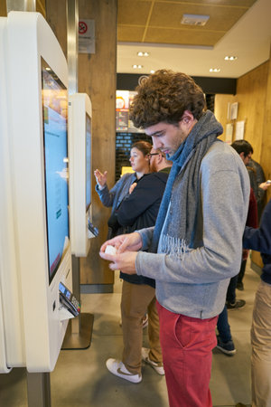 ROME, ITALY - CIRCA NOVEMBER, 2017: man use self-ordering kiosk at McDonald's restaurant in Rome.のeditorial素材