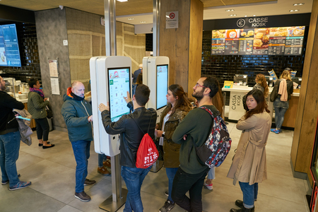 ROME, ITALY - CIRCA NOVEMBER, 2017: customers use self-ordering kiosks at McDonald's restaurant in...
