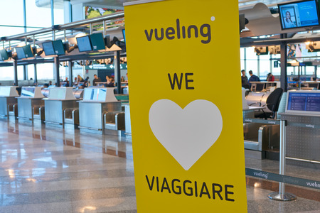 MILAN MALPENSA, ITALY - CIRCA NOVEMBER, 2017: close up shot of vueling sign at check-in area in Milan-Malpensa airport, Terminal 1.のeditorial素材