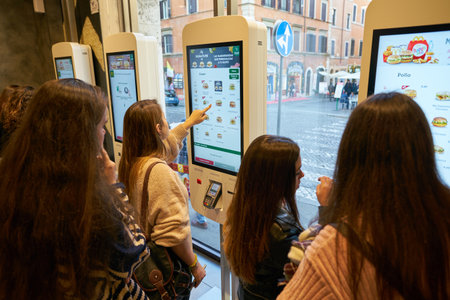 ROME, ITALY - CIRCA NOVEMBER, 2017: customers use self-ordering kiosks at McDonald's restaurant in...