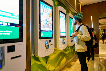 MILAN, ITALY - CIRCA NOVEMBER, 2017: customer at a McDonald's store place orders and pay through...