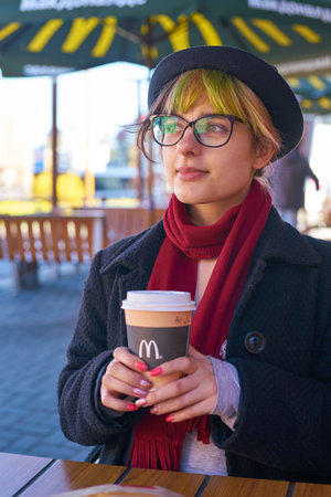 KALININGRAD, RUSSIA - CIRCA APRIL, 2018:  young woman with coffee from McDonald's in Kaliningrad.のeditorial素材
