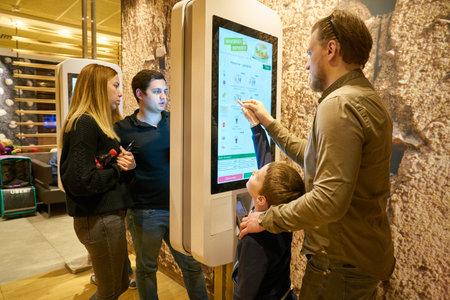 MOSCOW, RUSSIA - CIRCA MAY, 2018: people use ordering kiosk at McDonald's restaurant in Moscow.