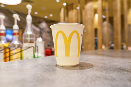 MOSCOW, RUSSIA - CIRCA MAY, 2018: close up shot of paper cup with water at McCafe in Moscowのeditorial素材