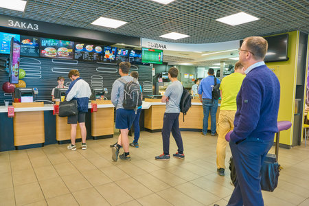 SAINT PETERSBURG, RUSSIA - CIRCA MAY, 2018: people at McDonald's restaurant in Pulkovo airport.