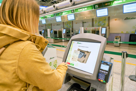 ROME, ITALY - CIRCA NOVEMBER, 2017: woman use self check-in kiosks in Fiumicino International Airport "Leonardo da Vinci"のeditorial素材