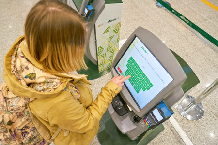 ROME, ITALY - CIRCA NOVEMBER, 2017: woman use self check-in kiosks in Fiumicino International Airport "Leonardo da Vinci"のeditorial素材