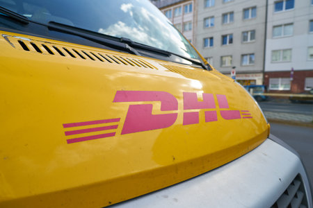 DUSSELDORF, GERMANY - CIRCA SEPTEMBER, 2018: close up shot of a DHL sign on a van in Dusseldorf.