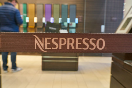 DUSSELDORF, GERMANY - CIRCA SEPTEMBER, 2018: close up shot of Nespresso sign on a belt. Nespresso...