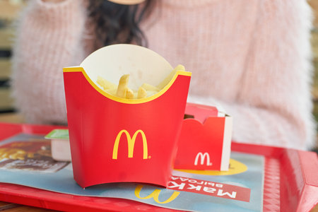 KALININGRAD, RUSSIA - OCTOBER 13, 2018: young woman with food served on tray at McDonald's restaurant.のeditorial素材